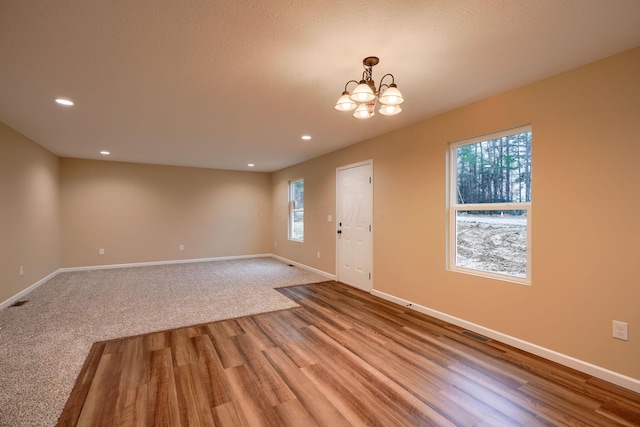 foyer entrance featuring baseboards, an inviting chandelier, and a healthy amount of sunlight