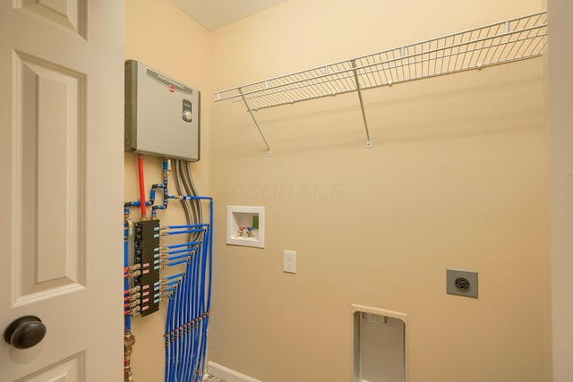 laundry area with hookup for a washing machine, laundry area, hookup for an electric dryer, and baseboards