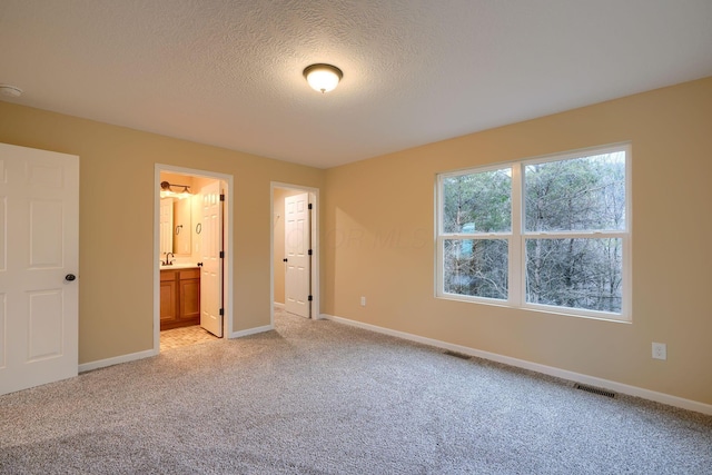 unfurnished bedroom with baseboards, visible vents, and light colored carpet