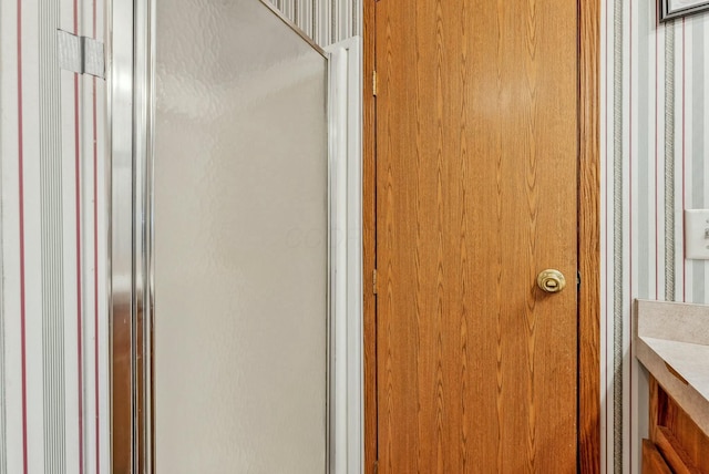 full bathroom featuring a shower with door