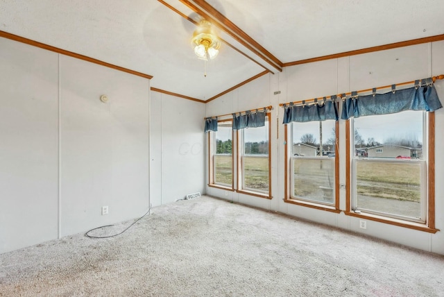 carpeted empty room featuring vaulted ceiling with beams and ornamental molding