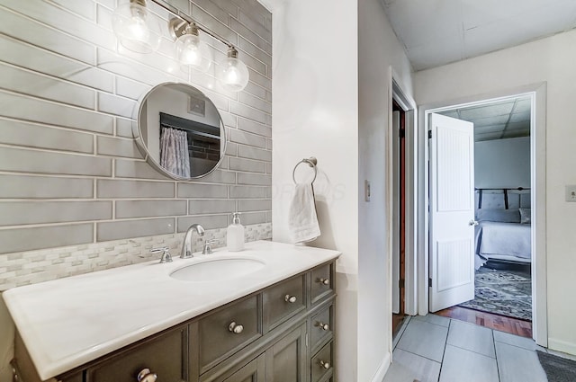 full bathroom featuring baseboards, vanity, and tile patterned floors