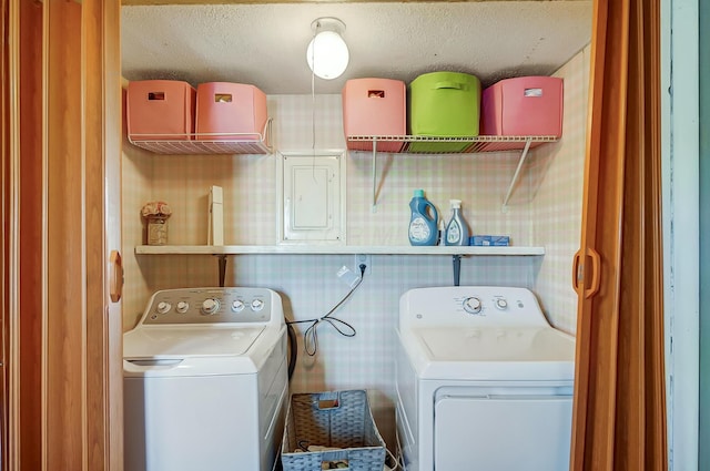 laundry area with a textured ceiling, laundry area, and washer and dryer