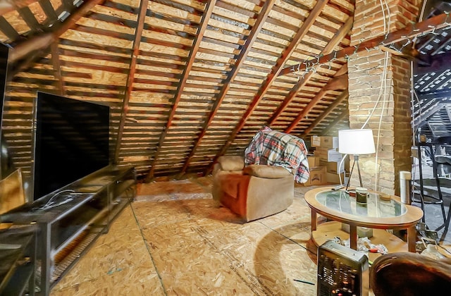 unfurnished living room featuring vaulted ceiling