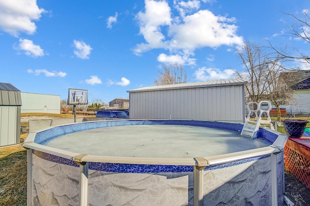 view of swimming pool featuring an outdoor structure