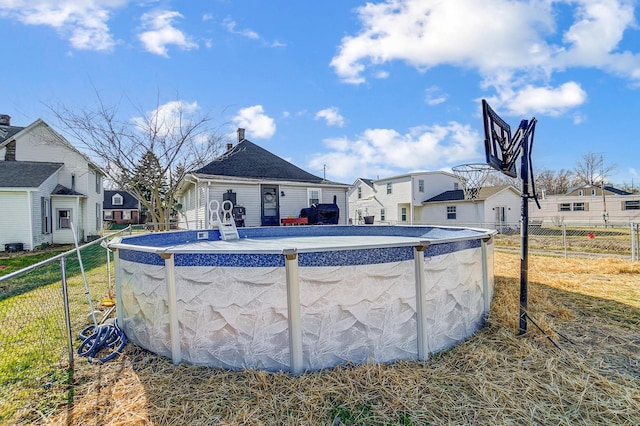 pool featuring a residential view and fence