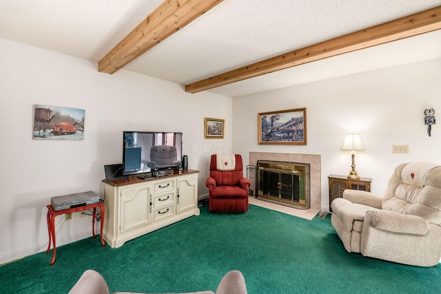 living area with beamed ceiling, dark carpet, a tile fireplace, and baseboards