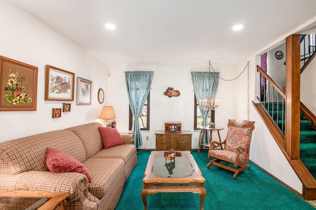 living room featuring stairs, a textured ceiling, carpet flooring, and baseboards