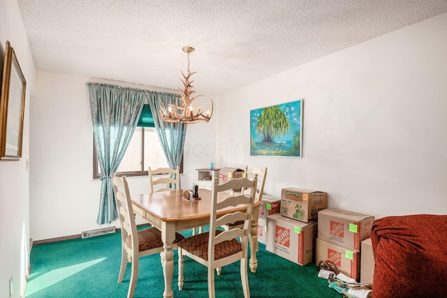 carpeted dining space featuring an inviting chandelier, baseboards, visible vents, and a textured ceiling