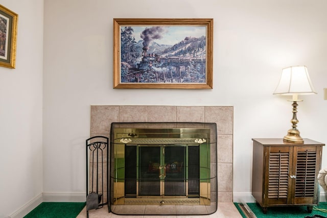 room details with baseboards and a tiled fireplace