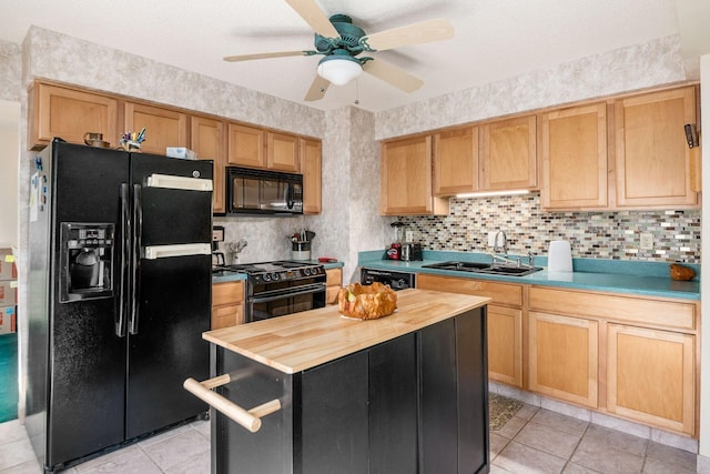 kitchen with tasteful backsplash, butcher block counters, a ceiling fan, a sink, and black appliances