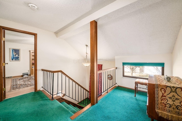 interior space featuring baseboards, vaulted ceiling, a textured ceiling, and carpet flooring