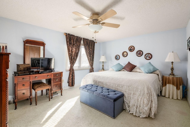 bedroom with carpet, ceiling fan, and a textured ceiling