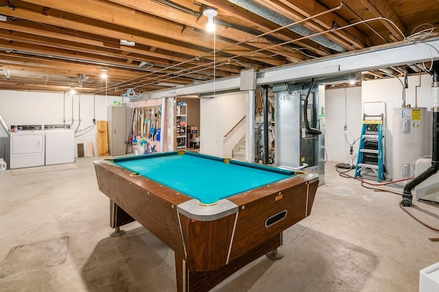 playroom featuring water heater, concrete floors, heating unit, and separate washer and dryer