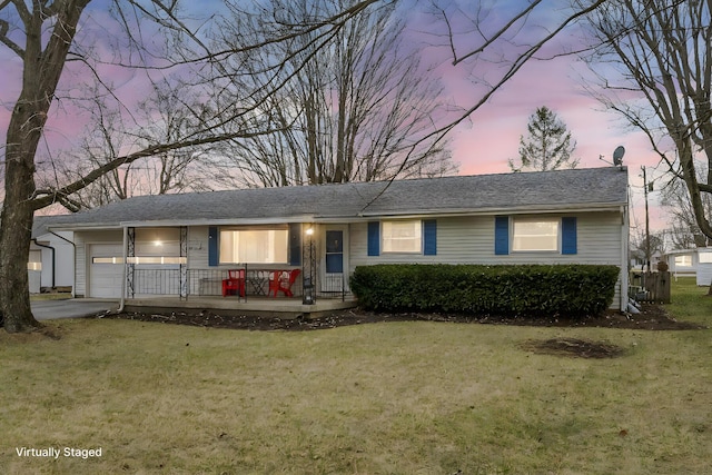 ranch-style home with a lawn, a garage, and a porch