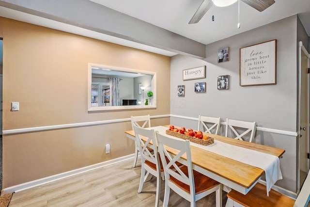 dining area with wood finished floors, baseboards, and ceiling fan
