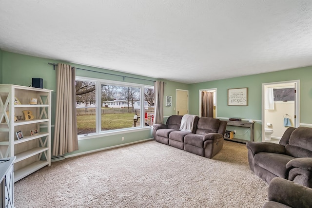 carpeted living room with baseboards and a textured ceiling