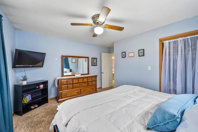 carpeted bedroom featuring baseboards and a ceiling fan