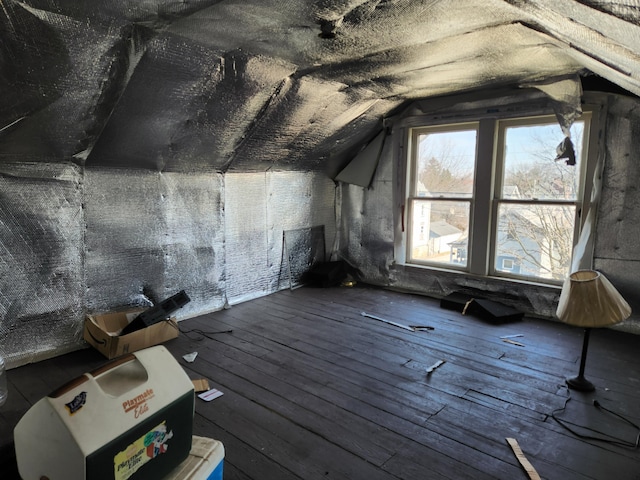 interior space featuring lofted ceiling and wood-type flooring