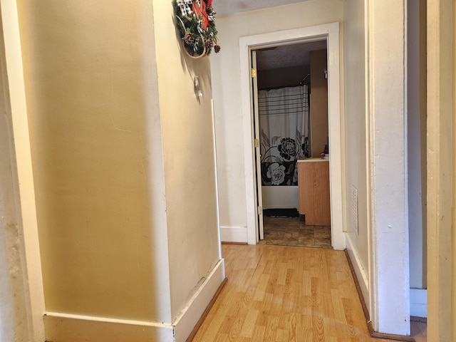 hallway with light wood-style floors