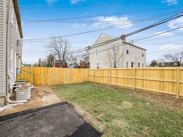 view of yard featuring fence private yard and central AC unit