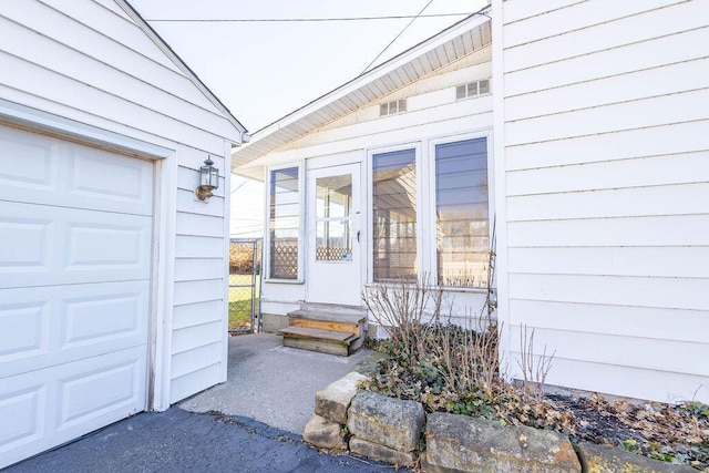 view of exterior entry with a garage