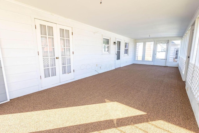 unfurnished sunroom with french doors