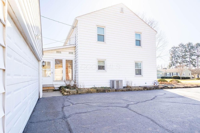 view of property exterior with entry steps and cooling unit