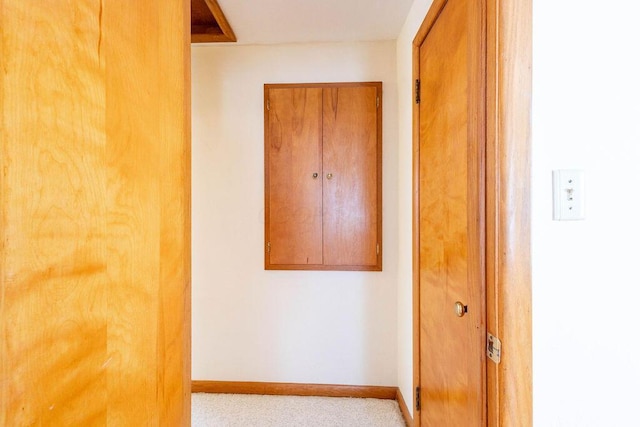 hallway featuring baseboards