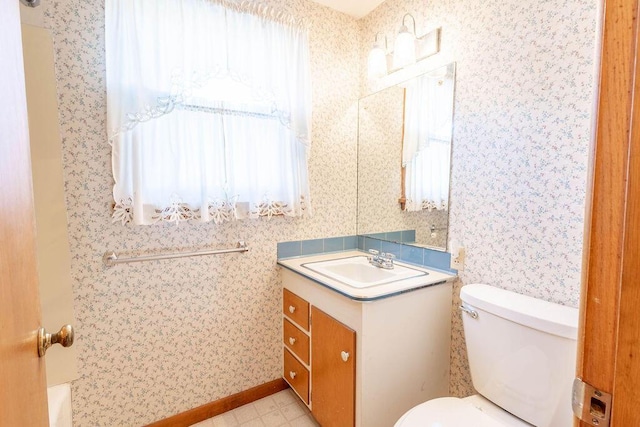 bathroom featuring toilet, wallpapered walls, tile patterned floors, and vanity