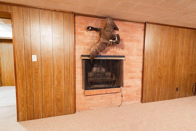 interior details with carpet floors, a brick fireplace, and wooden walls