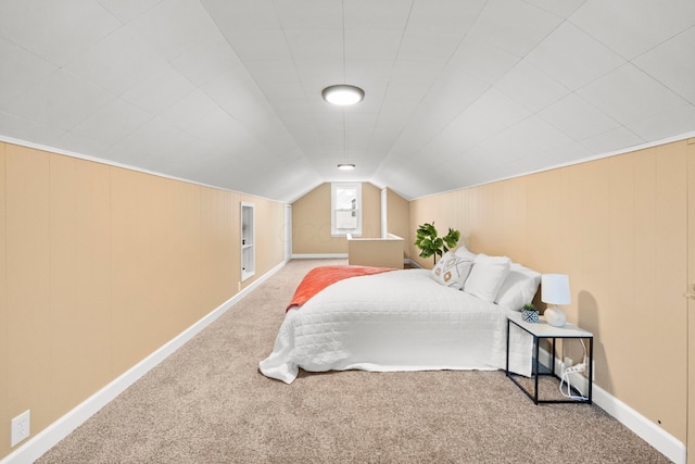 bedroom featuring lofted ceiling, carpet, and baseboards