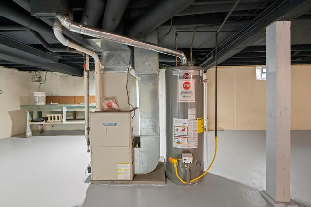 utility room featuring gas water heater and heating unit