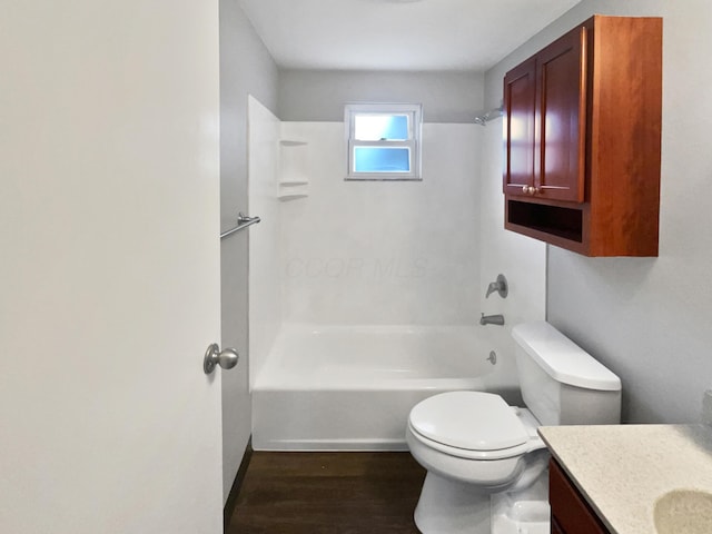 full bathroom with bathtub / shower combination, vanity, toilet, and wood finished floors