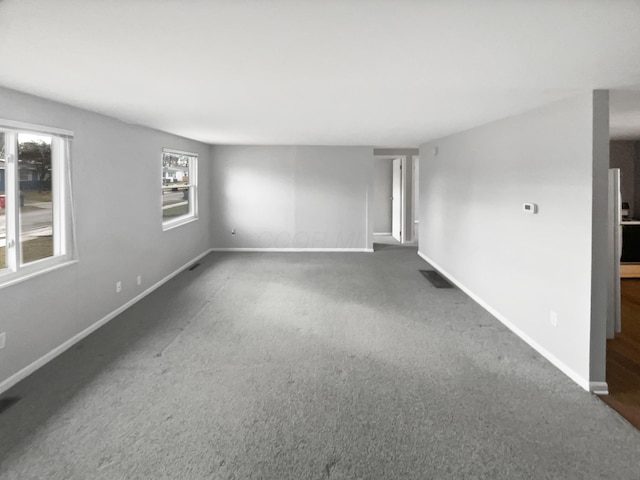 carpeted spare room with baseboards