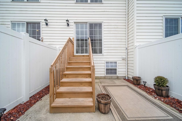 view of exterior entry featuring fence