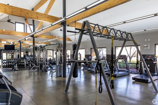 workout area with ceiling fan and a high ceiling