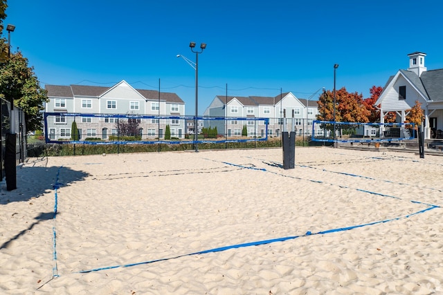 view of home's community featuring a residential view, fence, and volleyball court