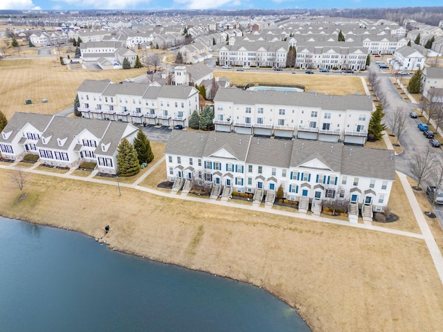 birds eye view of property with a water view and a residential view