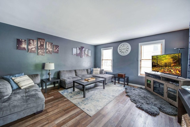 living area featuring baseboards and wood finished floors