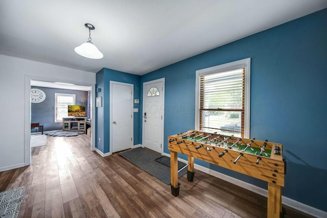 interior space featuring dark wood-style flooring and baseboards