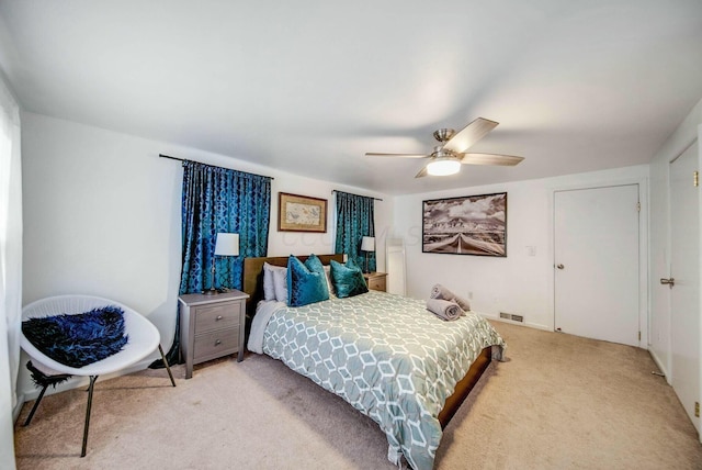 bedroom featuring light carpet, ceiling fan, and visible vents