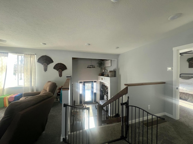 stairs featuring carpet, visible vents, a textured ceiling, and baseboards