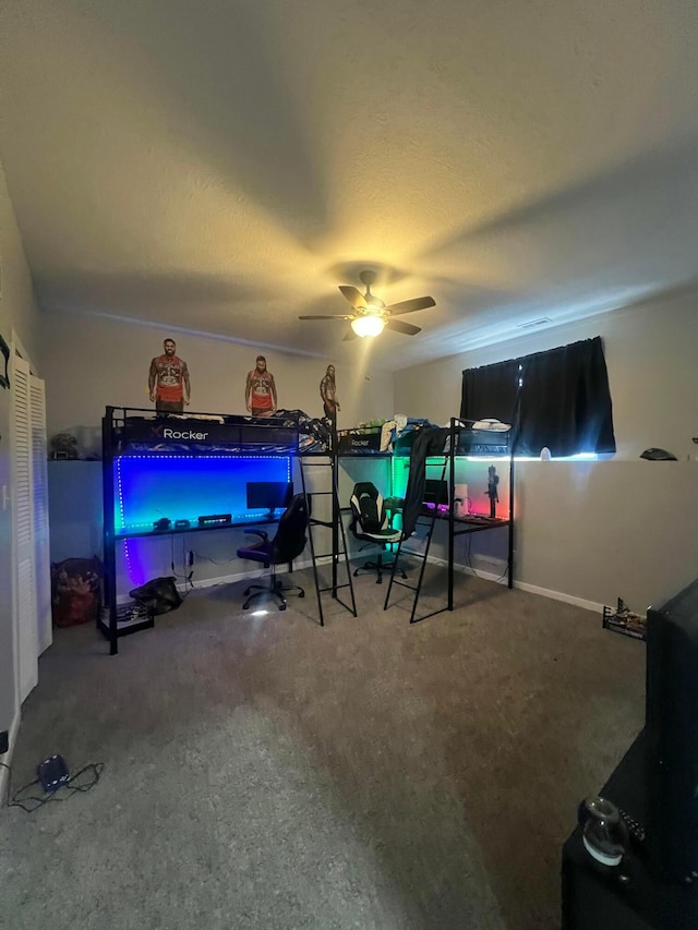 bedroom with a ceiling fan and a textured ceiling