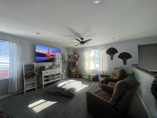 carpeted living room featuring a textured ceiling, a ceiling fan, and baseboards