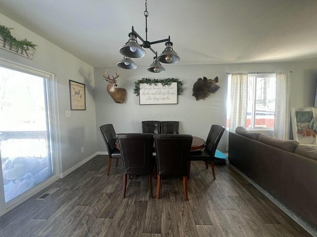 dining area featuring visible vents, baseboards, and dark wood-type flooring