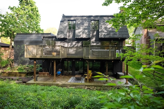 back of property featuring a deck