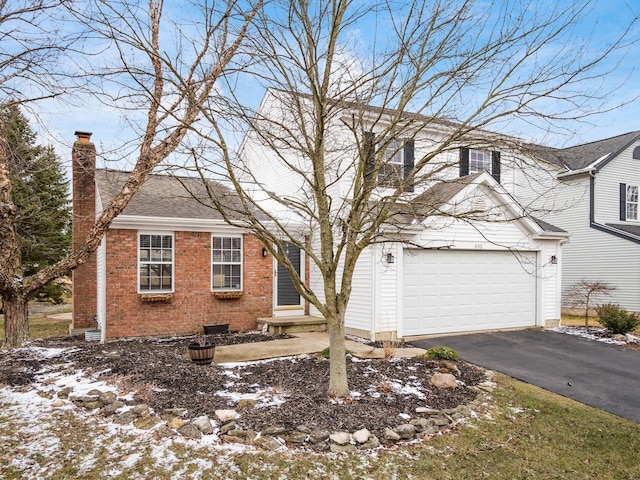 view of front facade with a garage, a chimney, aphalt driveway, roof with shingles, and brick siding