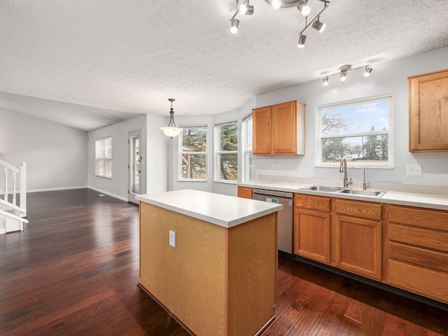 kitchen featuring stainless steel dishwasher, a kitchen island, a sink, and dark wood finished floors