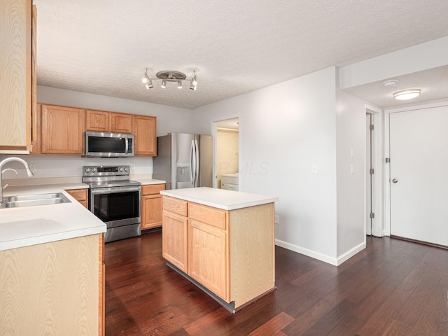 kitchen featuring a textured ceiling, stainless steel appliances, a sink, light countertops, and dark wood-style floors